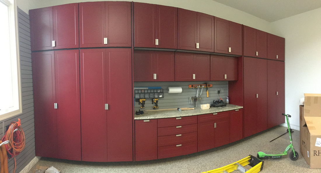 Completed red garage cabinet and slatwall installation