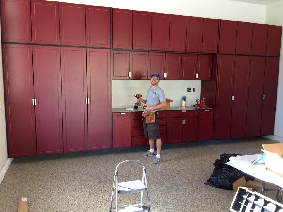 Ryan Peterson with an installation of red garage cabinets